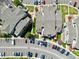 Aerial view shows multi-unit residential property with parking, landscaping, and nearby green spaces at 970 S Dawson Way # 9, Aurora, CO 80012