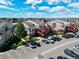 Aerial view showcasing the property, adjacent parking lot, and the neighborhood's well-manicured landscaping at 970 S Dawson Way # 9, Aurora, CO 80012