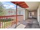 A spacious outdoor balcony with a red railing offers a comfortable space for relaxing outdoors at 970 S Dawson Way # 9, Aurora, CO 80012