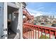 Cozy balcony with red railings offers a picturesque view of the well-maintained community and clear, blue sky at 970 S Dawson Way # 9, Aurora, CO 80012