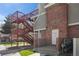 Exterior view of residential building with brick facade, utility access, and fire escape stairs at 970 S Dawson Way # 9, Aurora, CO 80012