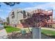 Exterior view of a multi-story home with balconies, garden space, and exterior stairs at 970 S Dawson Way # 9, Aurora, CO 80012