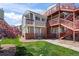 Residential building features brick accents, well-maintained lawn, and outdoor stair access at 970 S Dawson Way # 9, Aurora, CO 80012