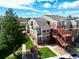 Exterior view of multi-story residential building with green lawn and landscaping at 970 S Dawson Way # 9, Aurora, CO 80012