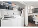 Functional laundry area with shelving and adjacent half bath at 970 S Dawson Way # 9, Aurora, CO 80012
