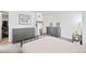 Serene main bedroom with gray dressers, a large mirror, and an organized closet with ample storage at 970 S Dawson Way # 9, Aurora, CO 80012