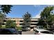 Apartment building exterior featuring multiple units and mature trees at 2500 S York St # 115, Denver, CO 80210