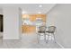 Bright kitchen with ample cabinet space, white appliances, and breakfast bar seating at 2500 S York St # 115, Denver, CO 80210