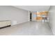 Open-concept living area with tile floors and a view of the kitchen and breakfast bar at 2500 S York St # 115, Denver, CO 80210