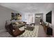 Inviting living room with comfortable seating, stylish decor, and a sliding glass door to a private patio at 2500 S York St # 115, Denver, CO 80210