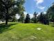 Inviting park featuring lush green grass, mature trees, and historical monument at 2500 S York St # 115, Denver, CO 80210
