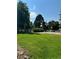 Beautiful park featuring lush green grass, mature trees, picnic area, and basketball courts at 2500 S York St # 115, Denver, CO 80210