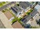 Aerial view of modern home with solar panels, fenced backyard with artificial turf, and a patio at 2426 Ames St, Edgewater, CO 80214