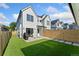 Backyard with artificial grass, concrete patio, modern fencing, and outdoor entertaining space at 2426 Ames St, Edgewater, CO 80214