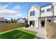 Backyard featuring artificial grass, concrete patio, modern fence, and a grill at 2426 Ames St, Edgewater, CO 80214