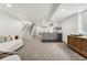 Finished basement with gray wet bar, recessed lighting, modern staircase, and neutral colored carpet at 2426 Ames St, Edgewater, CO 80214