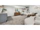 Finished basement with a gray accent bar, open shelving, and a white curved sofa for a comfortable living space at 2426 Ames St, Edgewater, CO 80214