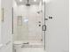 Stylish bathroom features marble tile in a glass enclosed shower with black fixtures at 2426 Ames St, Edgewater, CO 80214