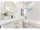 Chic bathroom featuring a framed mirror and a subway-tiled shower and tub combo at 2426 Ames St, Edgewater, CO 80214