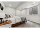 Cozy bedroom featuring a platform bed, carpeted floor, white walls, and a window for natural light at 2426 Ames St, Edgewater, CO 80214