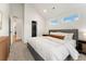 Bright bedroom features an ensuite bath, carpet floors, and a convenient walk-in closet at 2426 Ames St, Edgewater, CO 80214