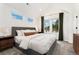 Bright bedroom with vaulted ceilings, neutral tones, plush carpet, and plenty of natural light at 2426 Ames St, Edgewater, CO 80214