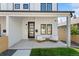 Inviting front porch with seating, showcasing the home's modern design with black accents and clean lines at 2426 Ames St, Edgewater, CO 80214