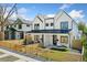 Charming two-story home featuring white siding, black accents, and a well-maintained front yard with a wooden fence at 2426 Ames St, Edgewater, CO 80214