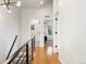 Hallway with hardwood floors and modern lighting, leading to various rooms at 2426 Ames St, Edgewater, CO 80214