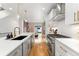 Open kitchen with stainless steel appliances, quartz countertops, and center island with gold hardware at 2426 Ames St, Edgewater, CO 80214