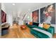 Spacious living room with hardwood floors, modern décor, a green velvet couch, and a view of the kitchen at 2426 Ames St, Edgewater, CO 80214