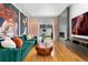 Cozy living room featuring a fireplace, large art pieces, stylish furniture, and backyard view at 2426 Ames St, Edgewater, CO 80214