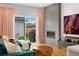 Modern living room with a fireplace, TV, and view of the outdoor space through sliding glass doors at 2426 Ames St, Edgewater, CO 80214