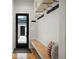 Functional mudroom with a built-in bench, coat hooks, and an exterior door for easy access at 2426 Ames St, Edgewater, CO 80214