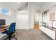 Spacious home office with stylish shelving and a window overlooking the neighborhood at 2426 Ames St, Edgewater, CO 80214