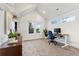 Bright home office with an ergonomic desk and large windows overlooking the yard at 2426 Ames St, Edgewater, CO 80214