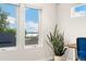 Large window shows a scenic view of the nearby lake and solar panels on neighborhood rooftops at 2426 Ames St, Edgewater, CO 80214