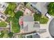 An aerial view of a well-maintained backyard with a garden, patio, lawn, and various outdoor features at 11100 Callaway Ct, Parker, CO 80138