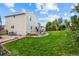 Large backyard with green lawn, mature trees, wooden deck, and storage shed at 11100 Callaway Ct, Parker, CO 80138