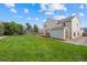 Spacious backyard features a large lawn, wooden deck, and storage shed on a sunny day at 11100 Callaway Ct, Parker, CO 80138