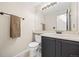 Half bathroom with a black cabinet vanity, neutral walls, decorative towel rack, and a large mirror at 11100 Callaway Ct, Parker, CO 80138
