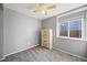 Bedroom with gray walls, carpeted floors, a window for natural light, and a wooden dresser at 11100 Callaway Ct, Parker, CO 80138