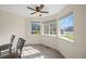 Bright dining area featuring wood floors, a ceiling fan, and large windows offering lots of natural light at 11100 Callaway Ct, Parker, CO 80138