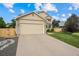 The home features a two-car garage, well-kept lawn, and traditional design elements at 11100 Callaway Ct, Parker, CO 80138