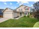 Inviting two-story home with red shutter accents, a well-kept lawn and two car garage at 11100 Callaway Ct, Parker, CO 80138
