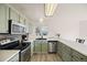 Well-lit kitchen with stainless steel appliances, plenty of counter space, and light green cabinets at 11100 Callaway Ct, Parker, CO 80138