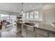 Modern kitchen featuring a stainless steel apron sink, granite countertops, and an open design to the living room at 10307 Vaughn Way, Commerce City, CO 80022