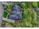 Aerial view showcasing the expansive property with lush landscaping, mature trees, and large backyard deck at 2597 Oak Vista Ct, Castle Rock, CO 80104