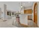 Basement wet bar with stone countertops, mini-fridge, wine rack, and bar seating at 2597 Oak Vista Ct, Castle Rock, CO 80104