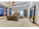 Bright bedroom boasts ceiling fan, multiple windows, large mirror, and a wrought iron bed frame at 2597 Oak Vista Ct, Castle Rock, CO 80104